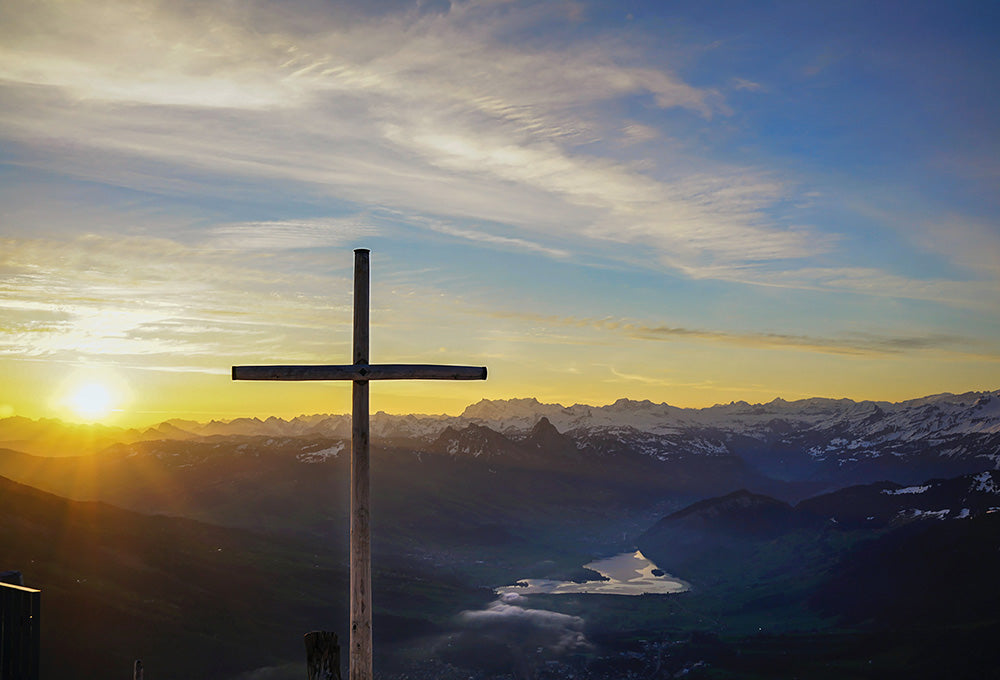 Christian cross on a hill representing that we are more than just conquerors
