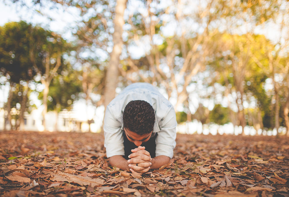 Man praying surrender in a personalized scripture journal