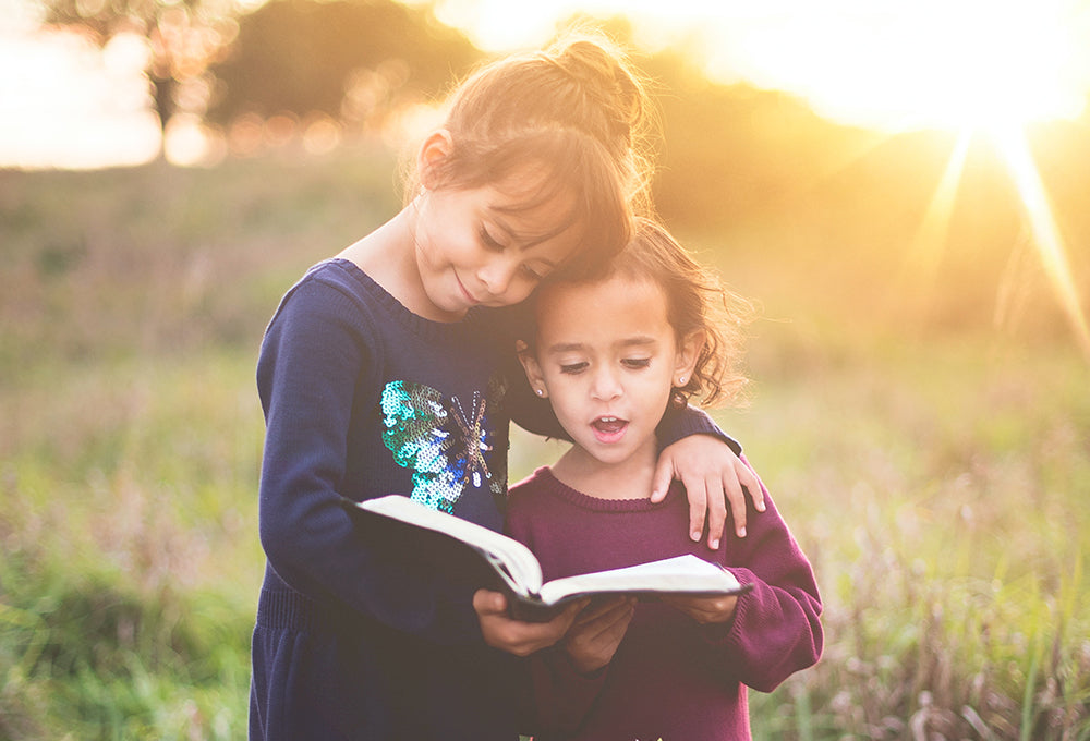 Two children reading personalized scripture journal reflecting on greatness in God's kingdom