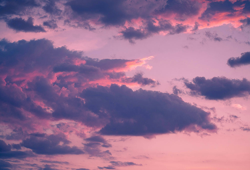 Serene clouds at sunset with purple skies reminding us that His mercies never fail
