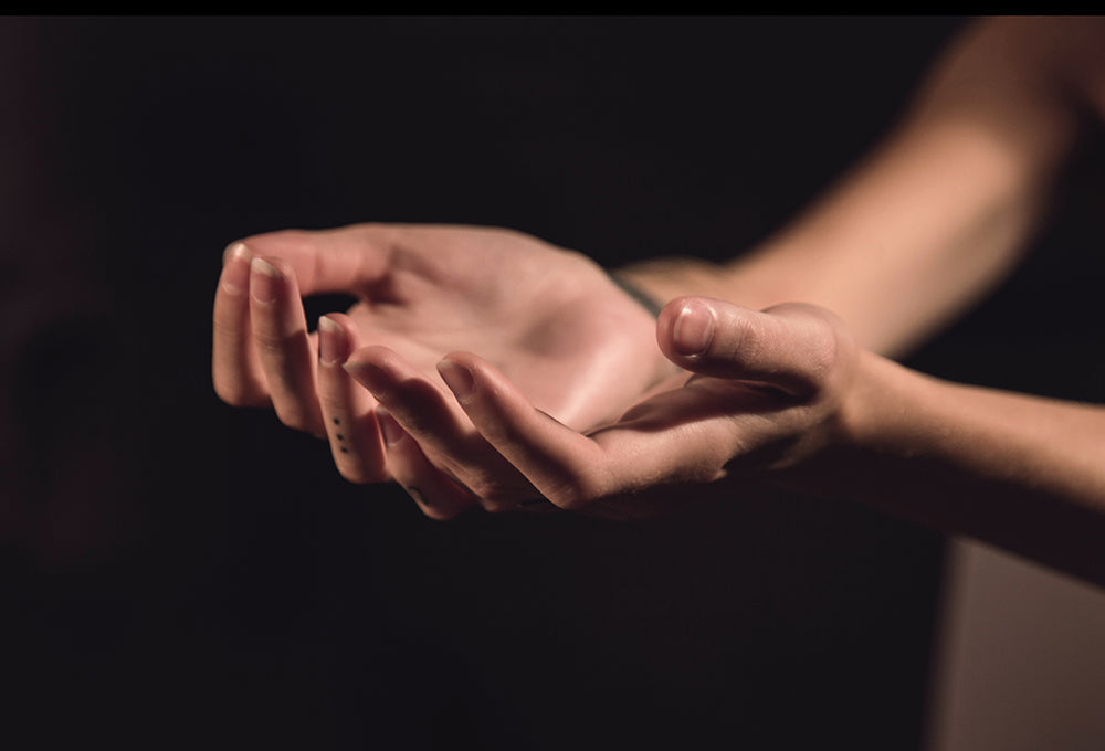 womans hands stretched out representing giving