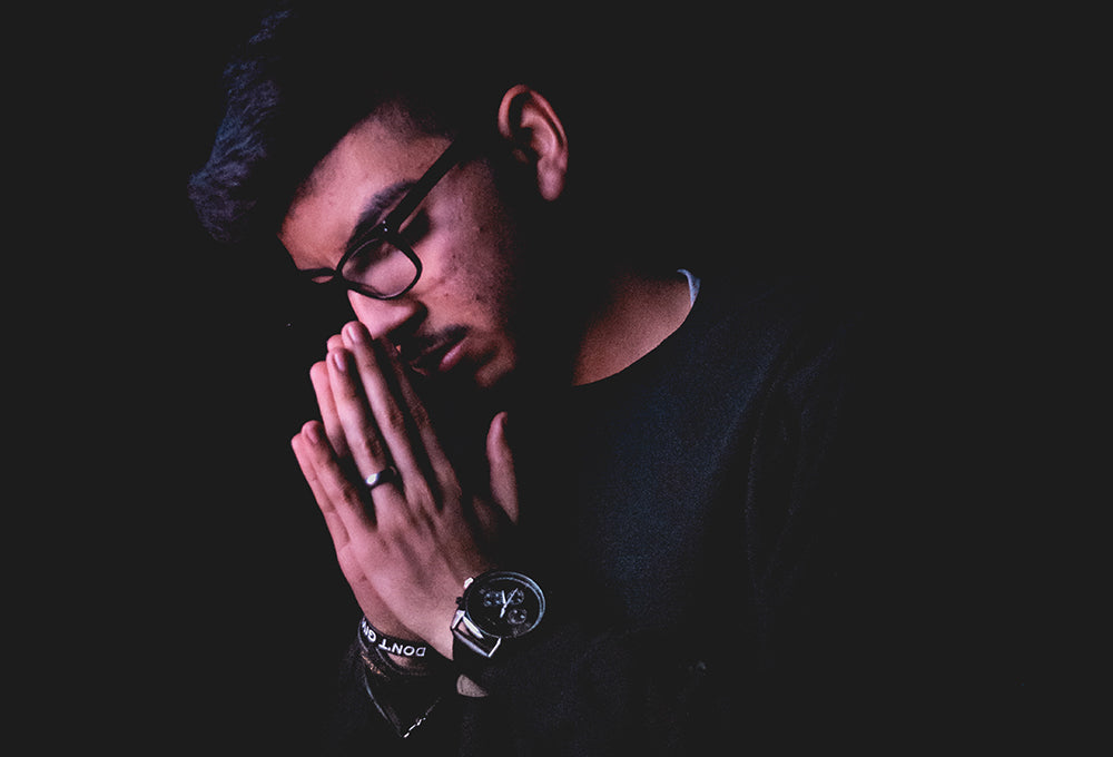 Man with hands praying embracing symbolizing forgiveness and reconciliation