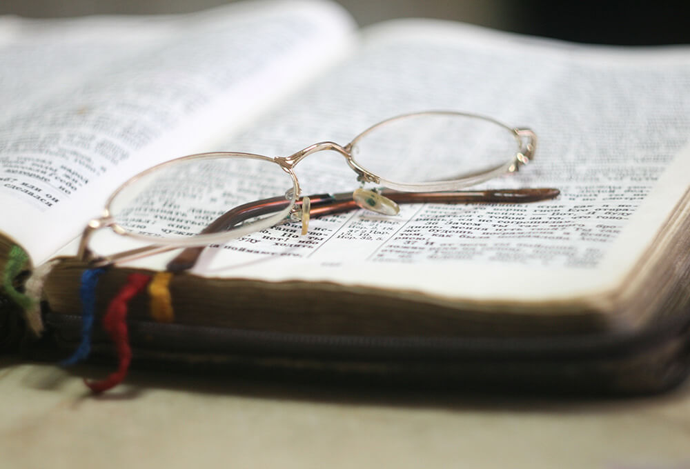 Reading glasses on a well used Bible