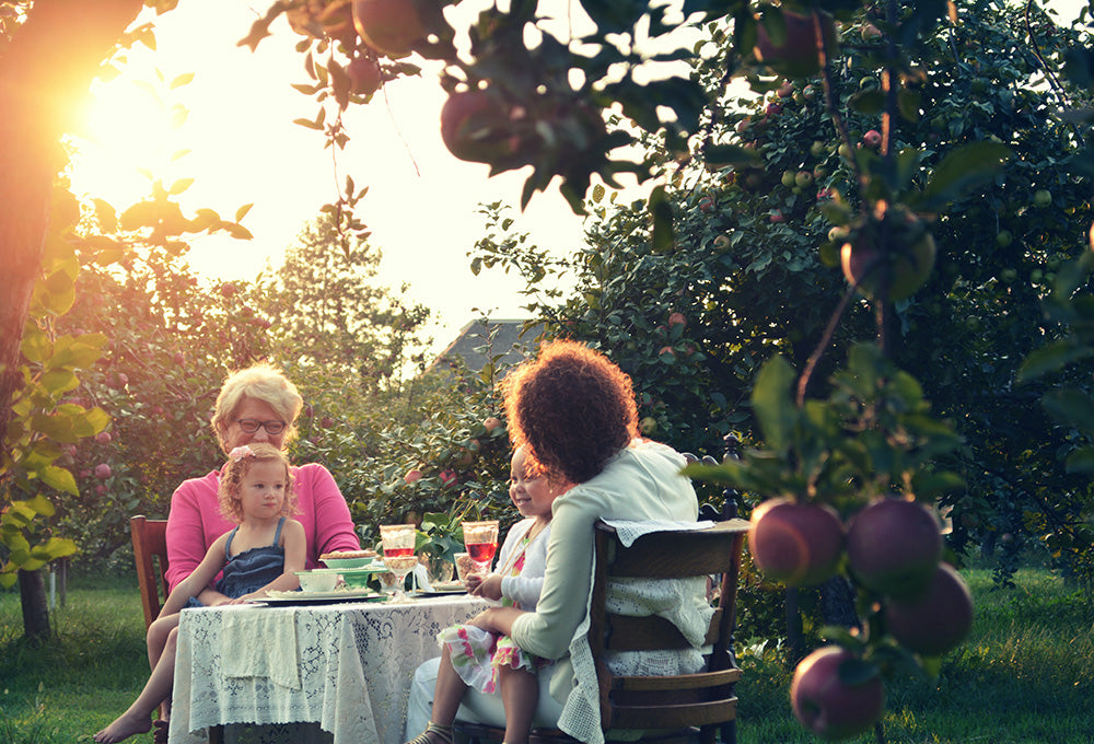 Family having a picnic in the garden with kids reflecting on being satisfied with God