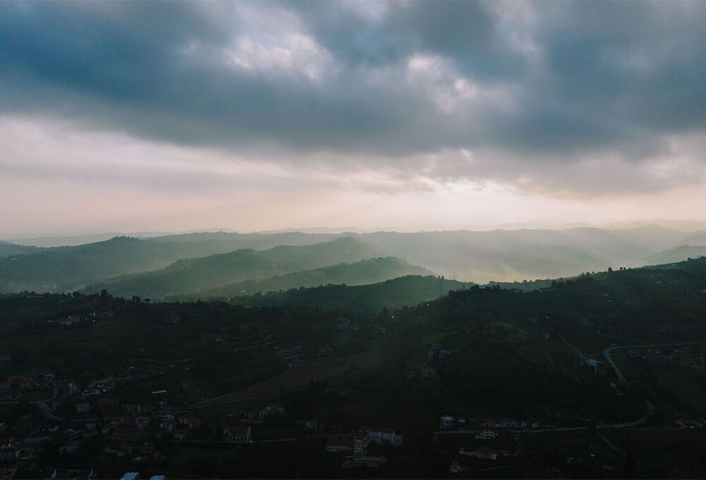Soft light breaking through clouds over a quiet landscape