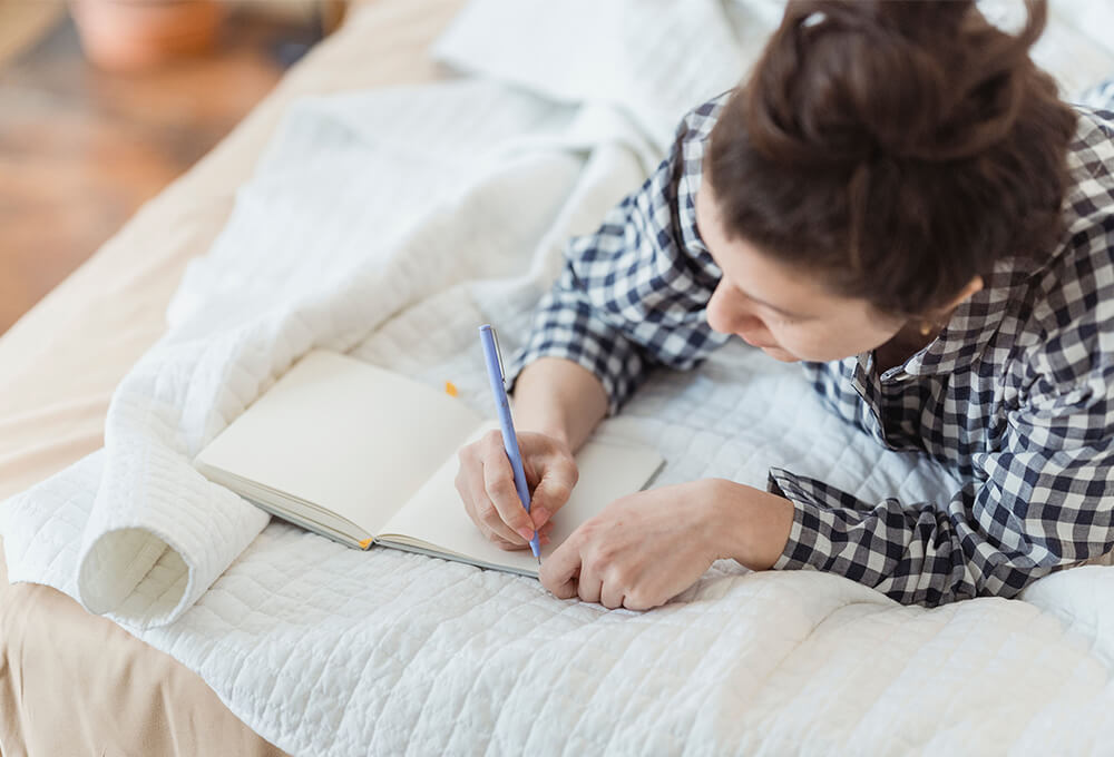 Woman journaling while reflecting on friendship and healing