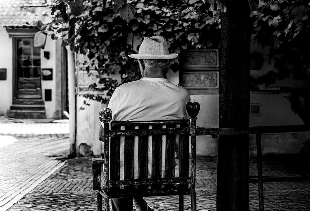 Man under a tree waiting with hope
