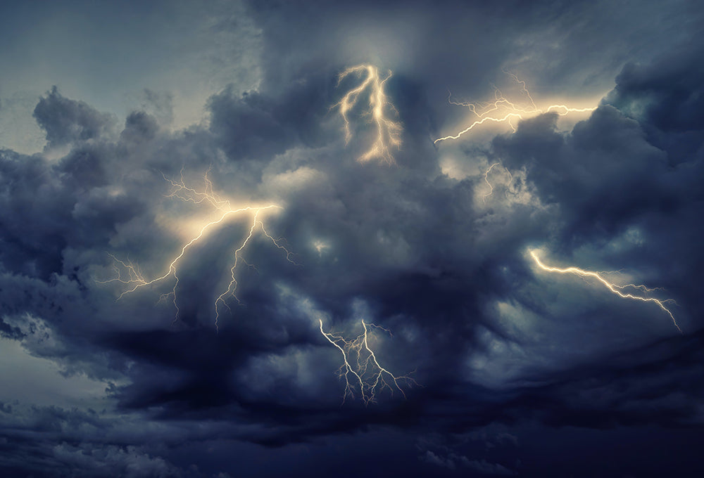 Dark storm clouds over landscape symbolizing God’s power