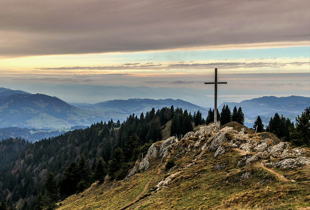 cross silhouette at sunset symbolic sacrifice and completion