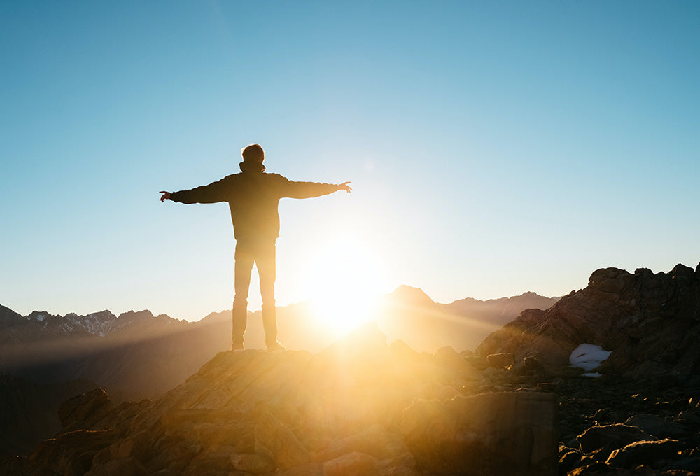 Man standing in daybreak symbolizing God’s blessing and favor