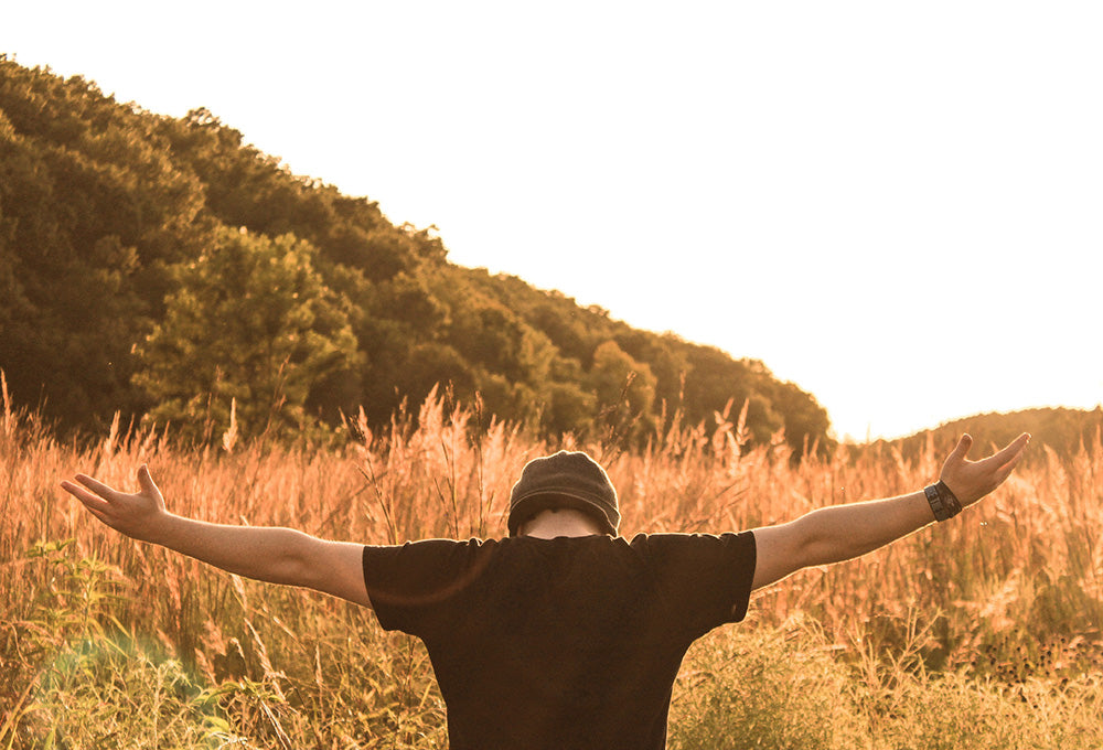 Man standing peacefully in sunlight symbolizing God’s loving presence