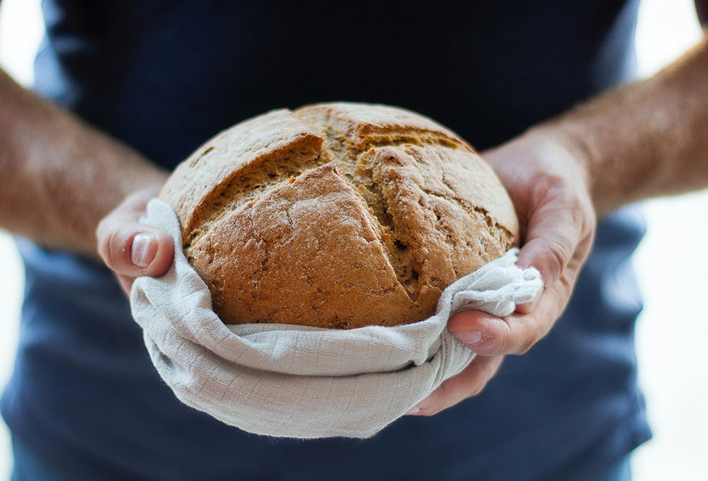 Man holding loaf of bread symbolizing honoring God in ordinary moments