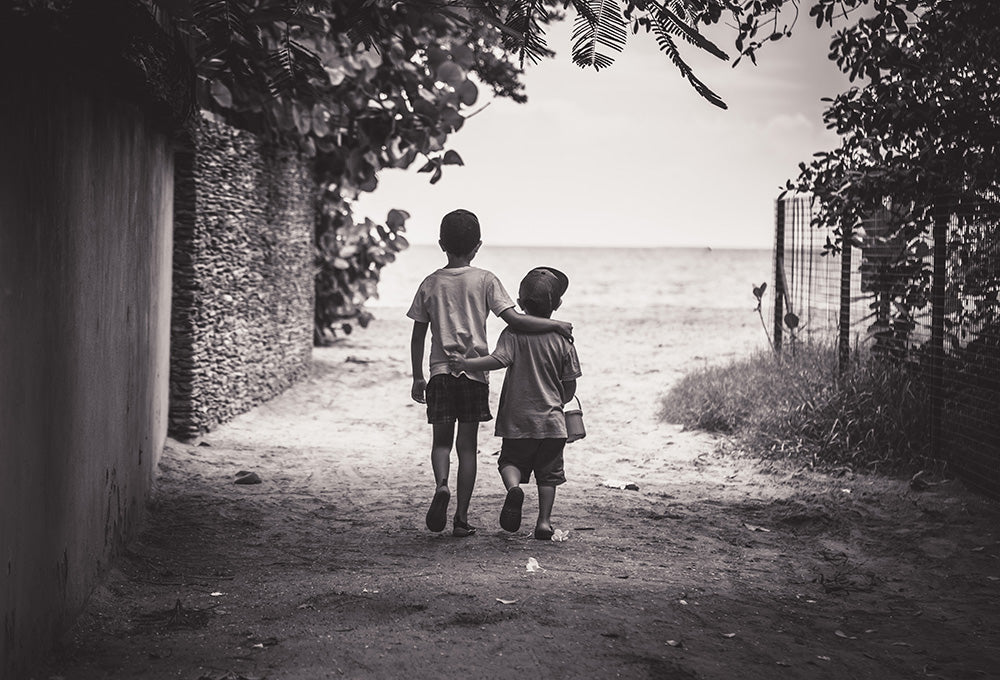 Child holding siblings hand symbolizing faith and trust