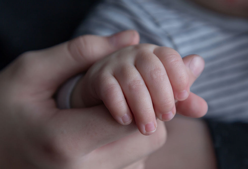 Image of a baby hand holding her mom's hand and showing that He will help you