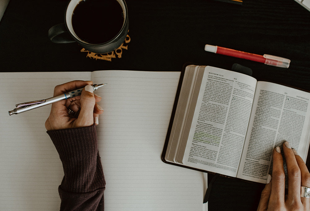 Writing reflections about spiritual growth in a personalized scripture journal