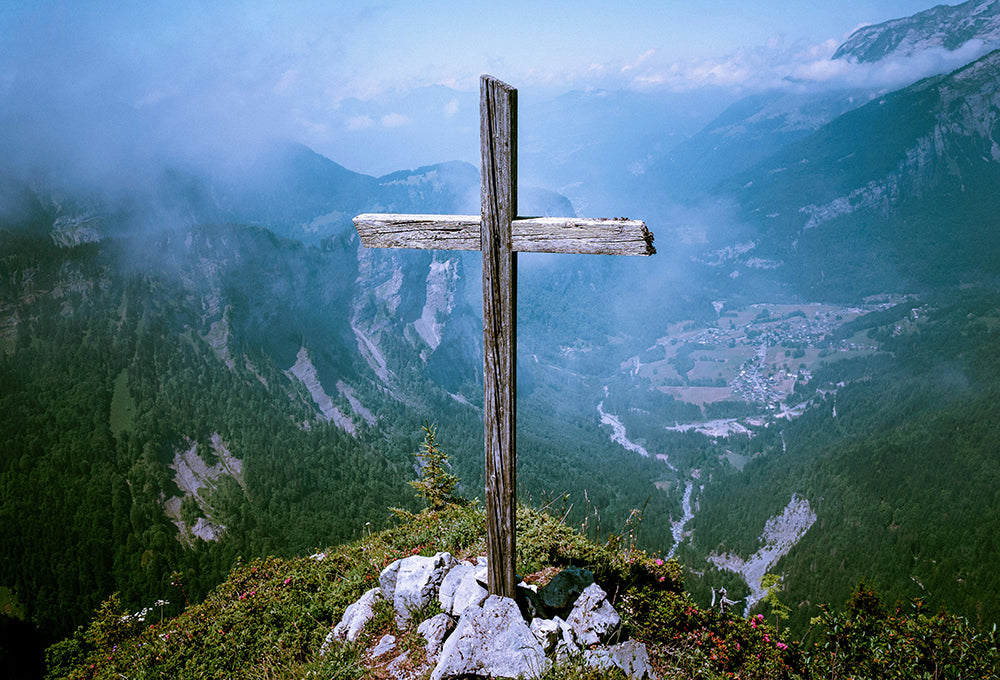 Cross on top of a hill revealing we are redeemed through His grace