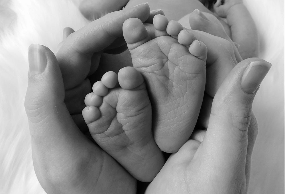 Baby feet in mothers hands symbolizing calling and new beginnings