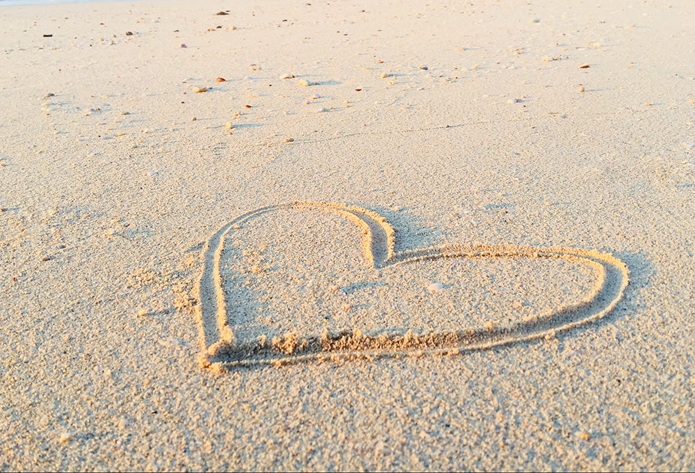 Heart drawn in sand symbolizing security and love