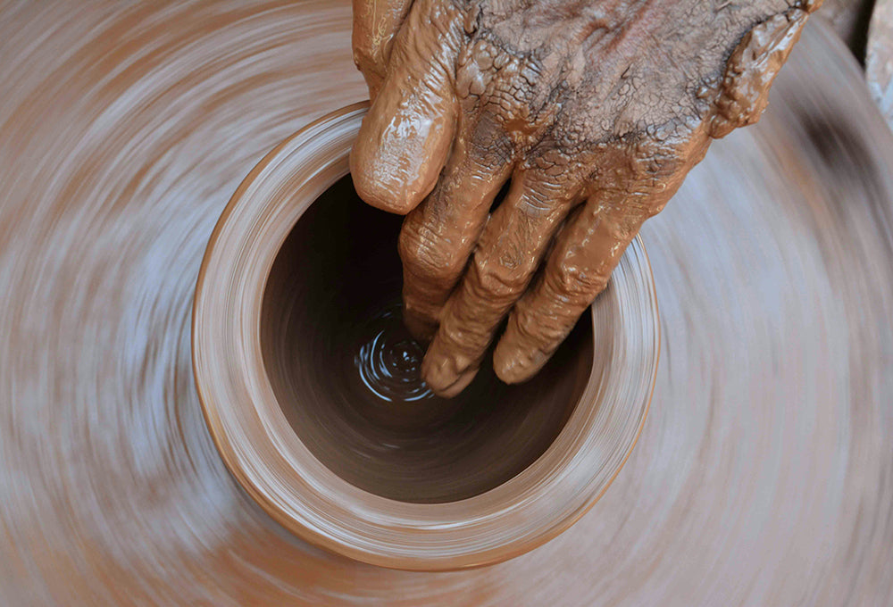 working raw clay symbolizing living out God’s purpose