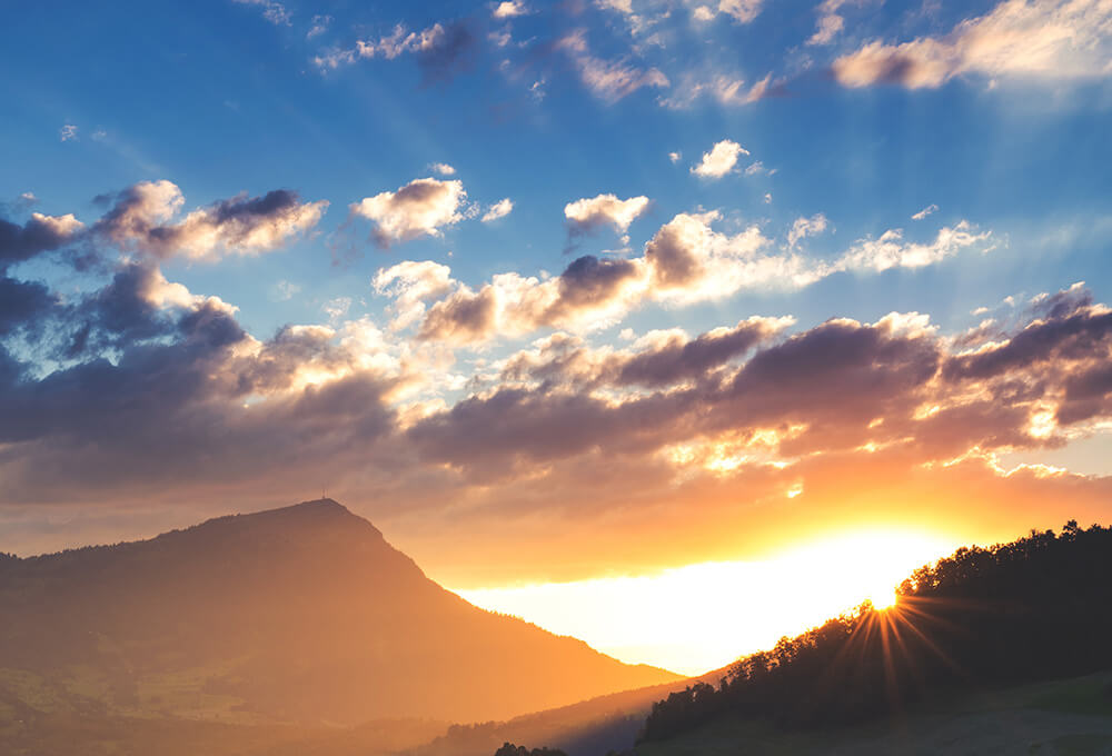 Sunrise over the mountains with crystal blue sky and clouds