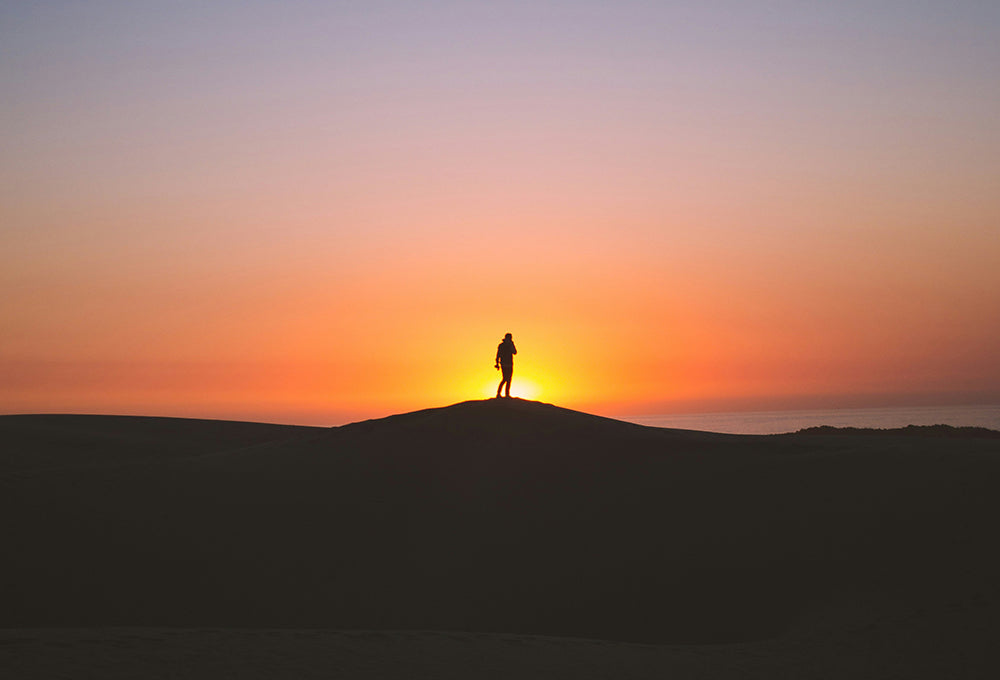Silhouette of person standing on hill