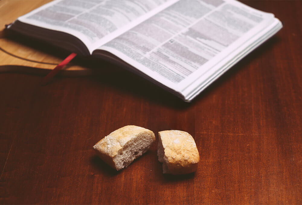Bread beside an open Bible representing daily provision