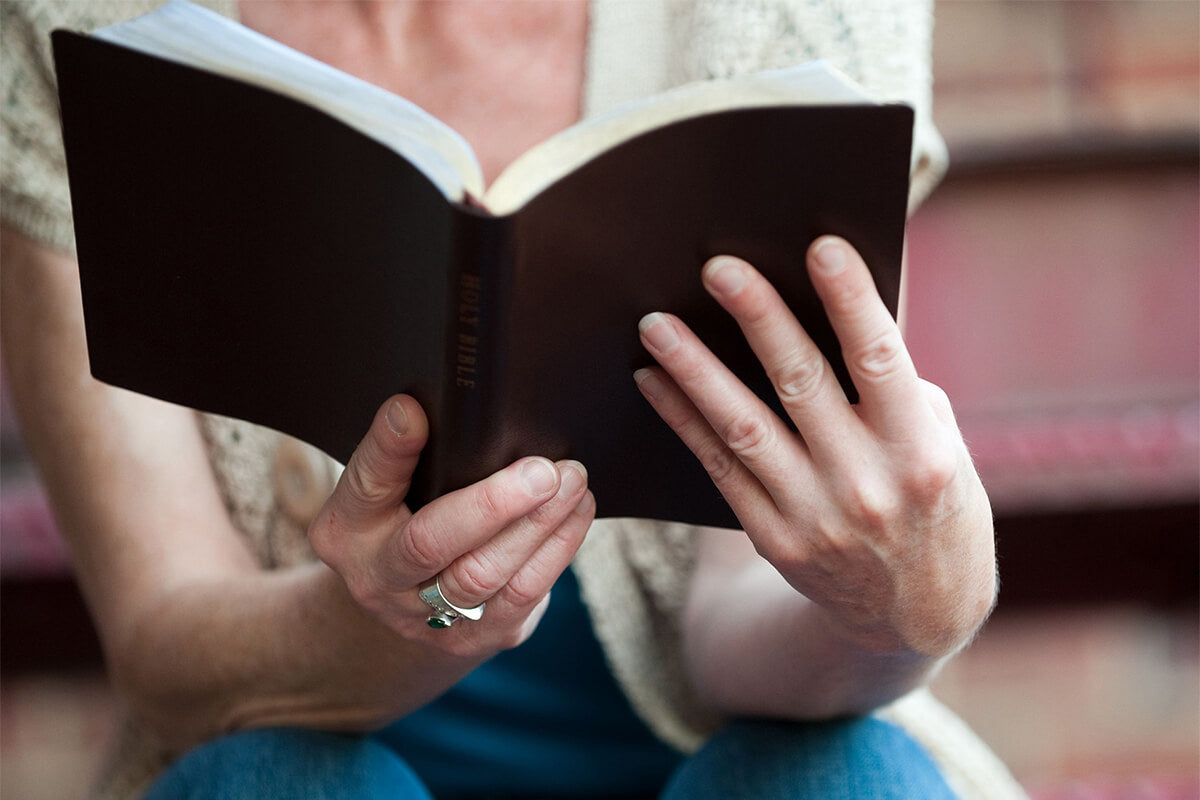 Woman journaling beside an open Bible while reflecting on how to guard her heart and grow in faith.