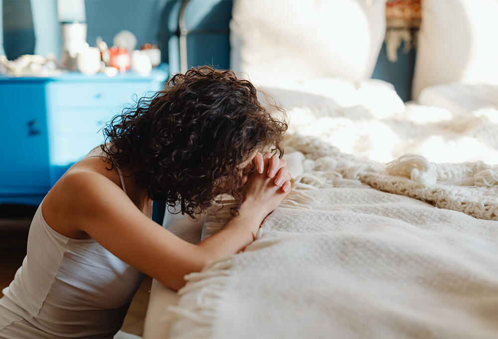 Woman praying quietly, letting go of worry
