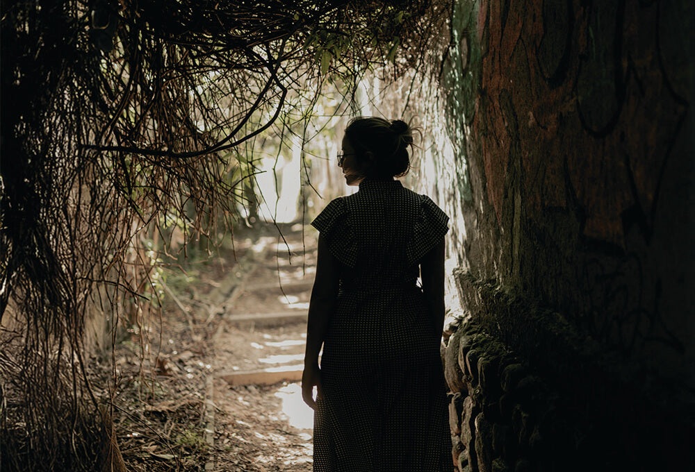 Woman walking on a dark path