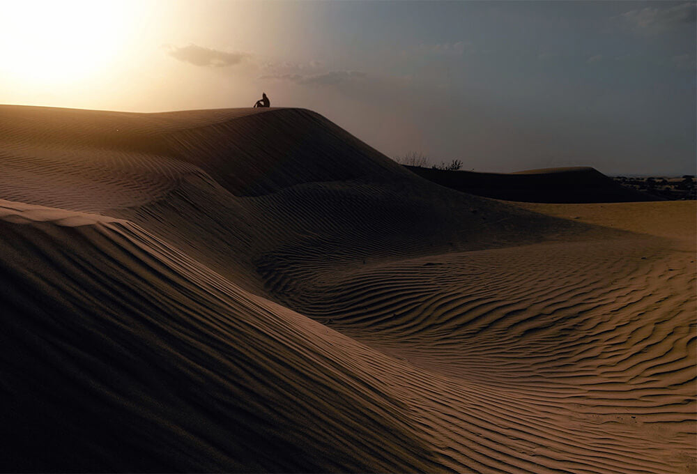 Person praying in the desert