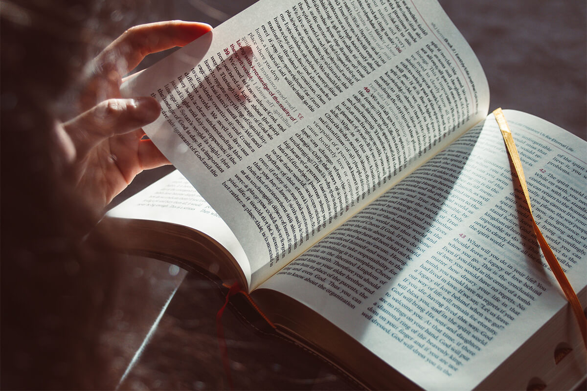 Woman reading the Bible and journaling about God's joy and strength