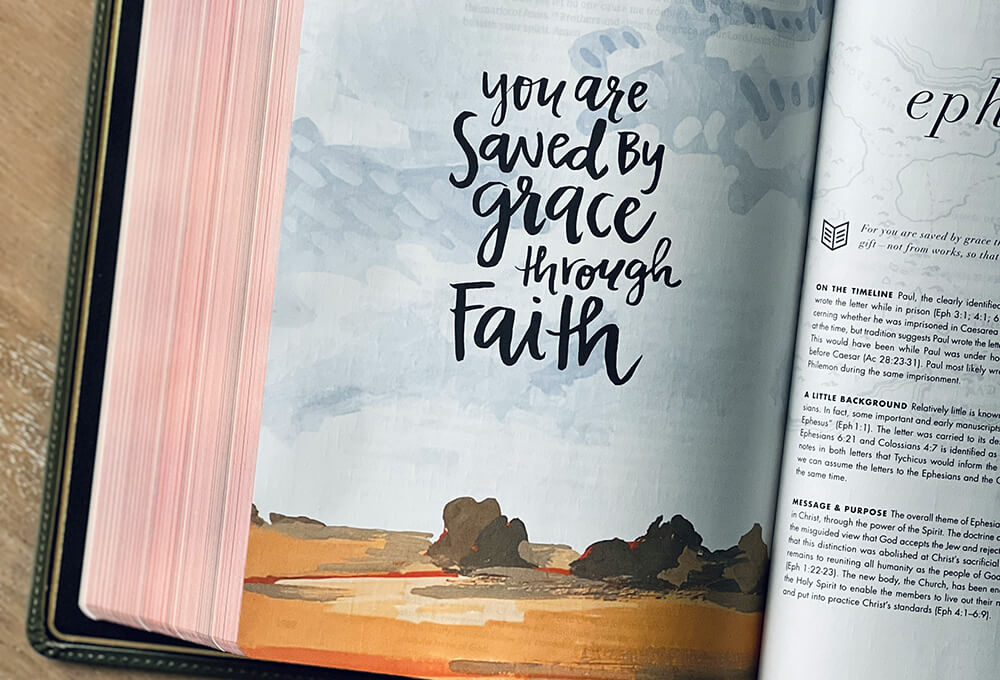 Open bible with uplifting phrase saying you are saved by grace through faith
