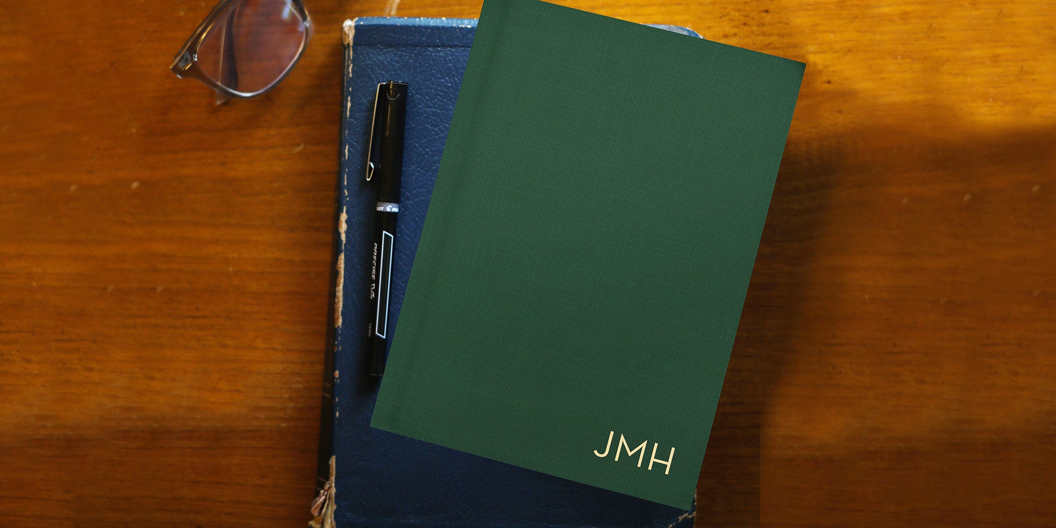 Personalized christian planner on desk with glasses, pen and Bible to represent the benefits of journaling