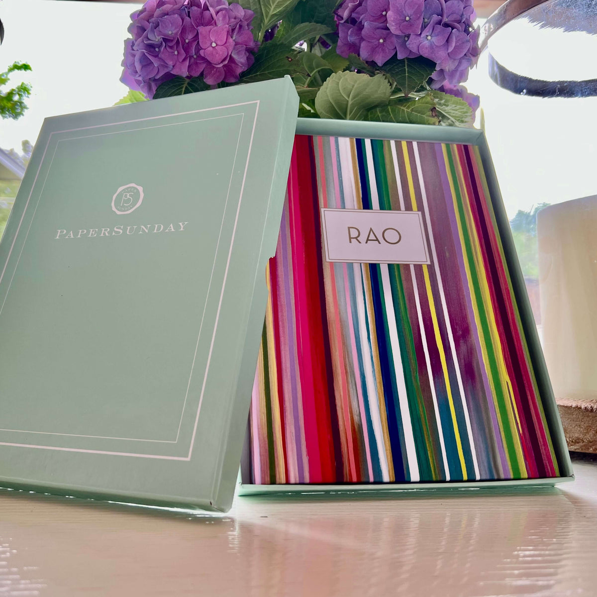 Purple flowers and a personalized scripture journal opened from its gift box