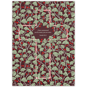 A planner cover featuring a red and green foliage pattern with a central cross design and text from Isaiah 43:6.