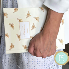 personalized white bumblebee planner with flexible soft cover and custom name on bee design in the hands of a business woman