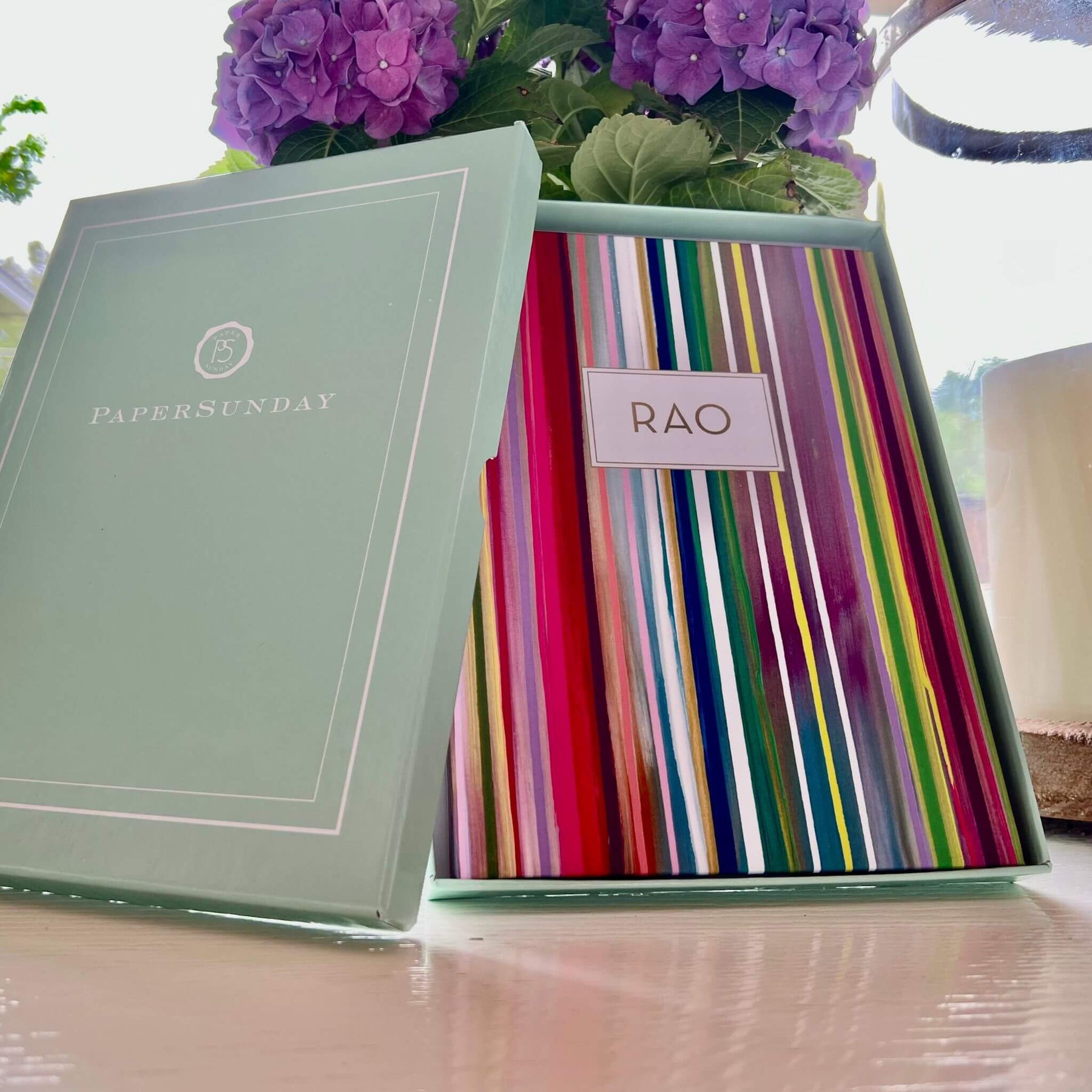 Starburst personalized scripture journal by Allison Castillo in an open gift box next to flowers, showcasing a gift-ready presentation with a unique curated set of Bible verses