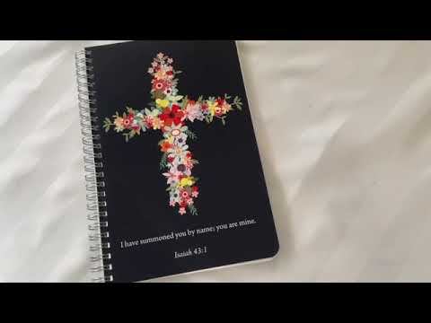 video showcasing navy floral cross planner with personalized cover and layout
